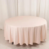 Pink round tablecloth draped elegantly over a circular table.