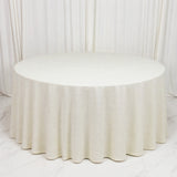 Elegant round ivory table with pleated linen drape on a white backdrop