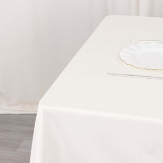 Create an Aura of Opulence with the Ivory Premium Scuba Wrinkle Free Square Table Overlay