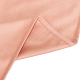 Close-up of soft peach fabric showing smooth texture and seam detail.