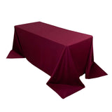 Burgundy tablecloth draped over a rectangular table
