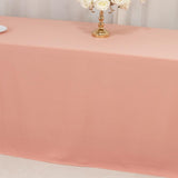 Elegant peach tablecloth draped over a table with a floral centerpiece.