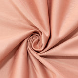 Peach-colored fabric with a smooth texture in a spiral arrangement. #whtbkgd
