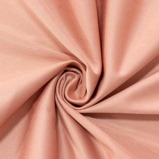 Peach-colored fabric with a smooth texture in a spiral arrangement. #whtbkgd