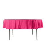 Pink tablecloth draped over a table on a plain white background.