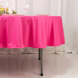 Pink tablecloth draped over a table with elegant glassware on a soft background.