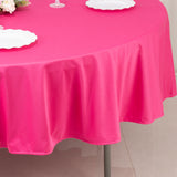 Pink tablecloth draping over a round table, creating a vibrant dining setup.