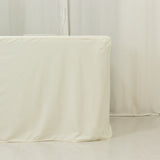 Table covered with a cream tablecloth in a minimalist setting.