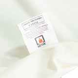 Inherently flame retardant fabric label on white textile