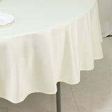 Cream round tablecloth draped elegantly over a table.