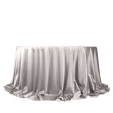 Silver satin tablecloth with elegant draping on a white background.