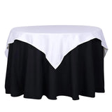 Round table with a white and black tablecloth, studio shot.