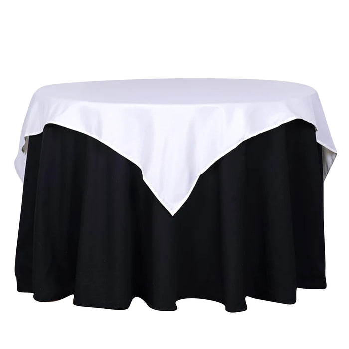 Round table with a white and black tablecloth, studio shot.