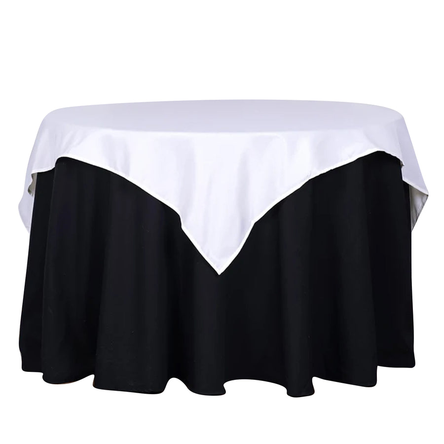 Round table with a white and black tablecloth, studio shot.