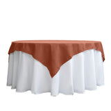 Brown tablecloth draped over a white table.