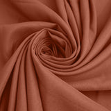 Rust-colored fabric in a spiral pattern showcasing its texture and softness. #whtbkgd