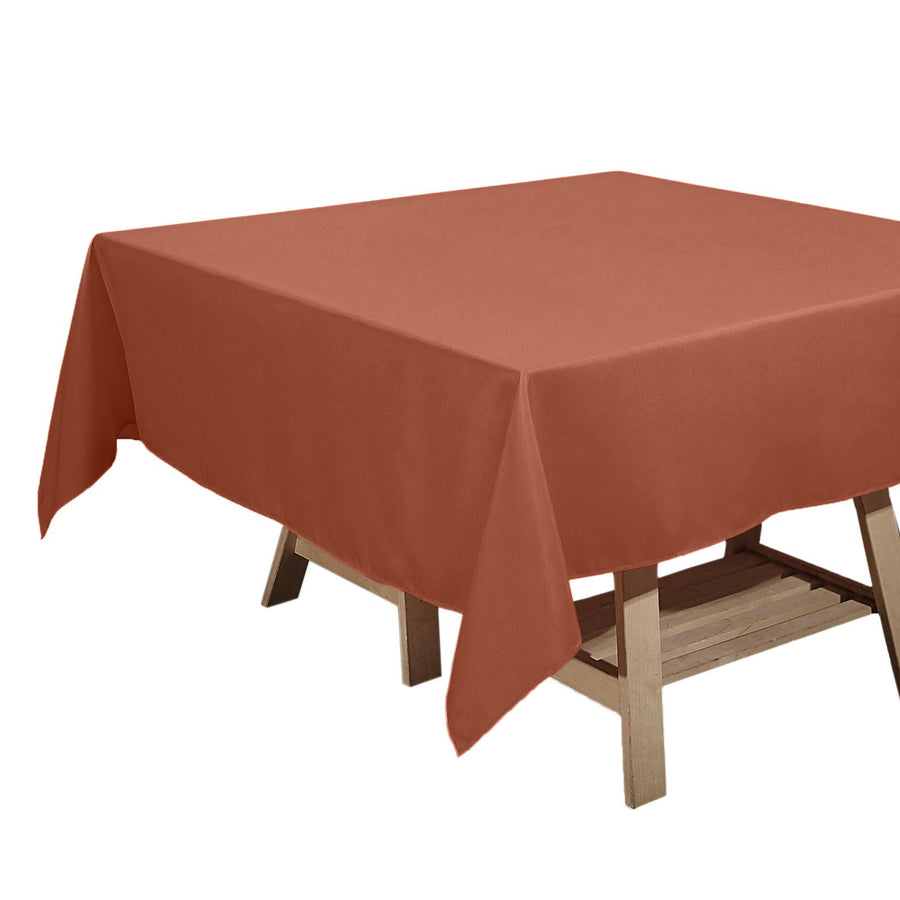 Rust-colored tablecloth draped over a wooden table