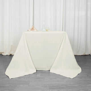 Experience Luxury and Convenience with the Ivory 90"x90" Seamless Premium Polyester Square Tablecloth