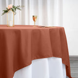Rust-colored tablecloth draping elegantly over a white table.