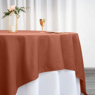 Rust-colored tablecloth draping elegantly over a white table.
