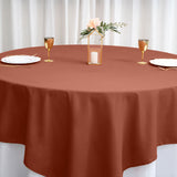 Rustic brown tablecloth on a round table set for an elegant dining experience.