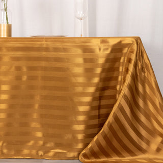 Elevate Your Event with the 90"x132" Gold Satin Stripe Seamless Rectangular Tablecloth