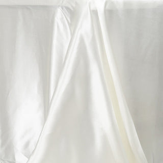 Create Unforgettable Moments with the Ivory Satin Seamless Rectangular Tablecloth