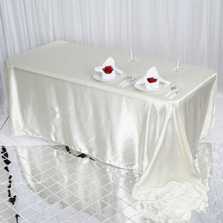 Enhance Your Event Decor with the Ivory Satin Seamless Rectangular Tablecloth