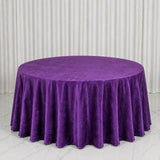 Purple round tablecloth on a round table with white curtain backdrop