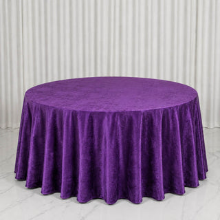 Purple round tablecloth on a round table with white curtain backdrop