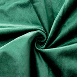 Emerald green velvet fabric close-up with soft folds and swirl texture#whtbkgd