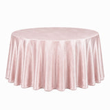Round table with blush pink velvet tablecloth on white background