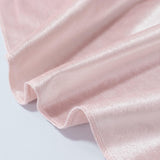 Light pink satin fabric close-up with soft ruffled folds