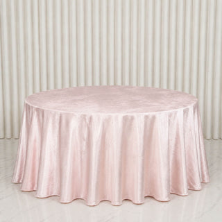 Round blush pink satin tablecloth on elegant banquet table backdrop