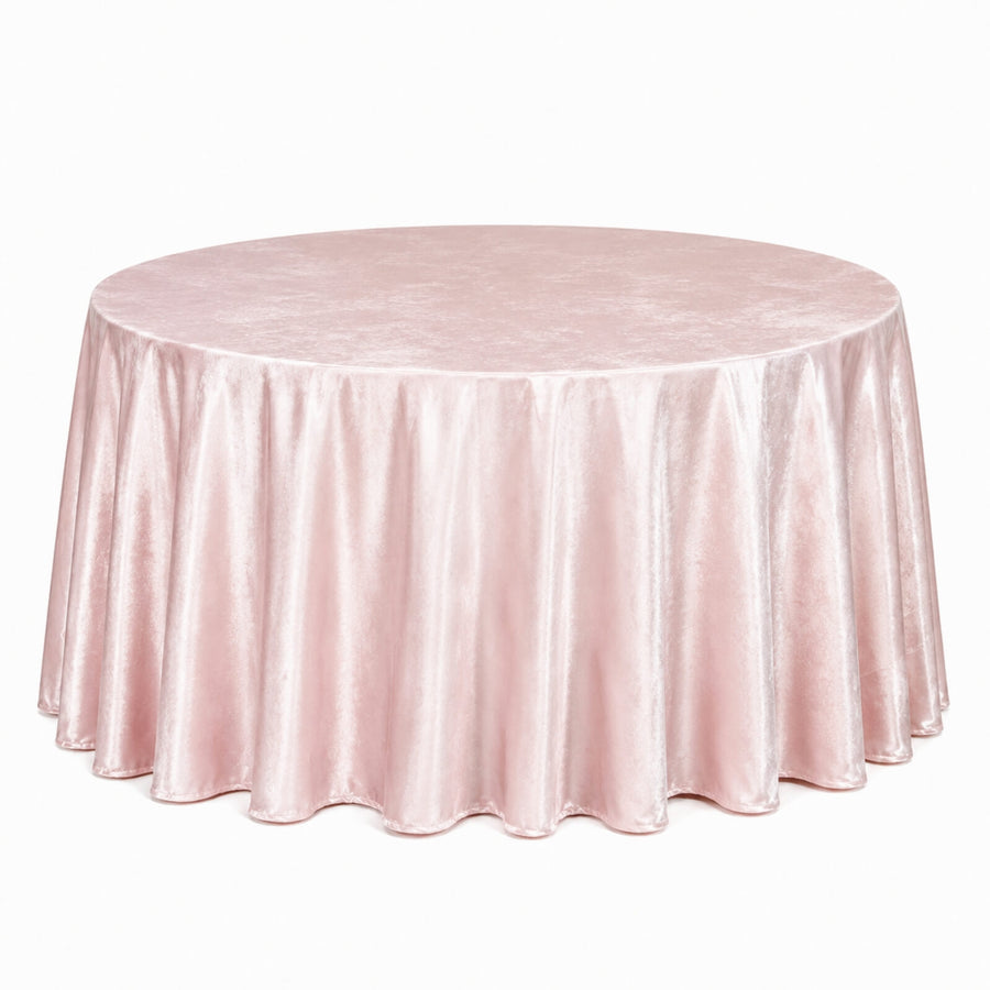 Round blush pink velvet tablecloth draped over a banquet table