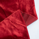 Red velvet fabric texture with stitched edges on white background