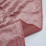 Pink satin fabric close-up with stitched hem and folded corner