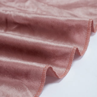 Rose gold satin fabric with scalloped edge and soft sheen close-up