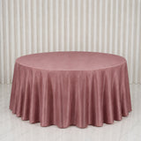 Round blush pink velvet tablecloth on a round table in a bright room