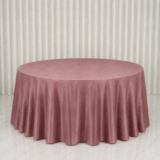 Round blush pink velvet tablecloth on a round table in a bright room
