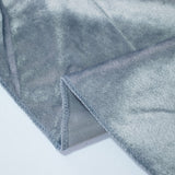 Grey woven fabric close-up with folded edge and visible stitching
