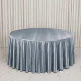 Round light blue velvet tablecloth on elegant draped table backdrop