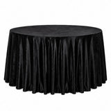 Black round table with velvet tablecloth on white background