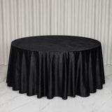 Round table with black velvet tablecloth in elegant event setting