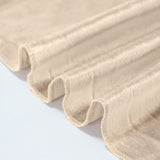 Beige sheer curtain fabric with soft folds and textured edges
