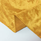 Gold velvet fabric close-up with stitched hem and folded corner