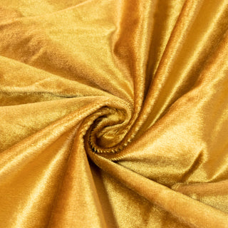 Golden satin fabric swirls with a glossy, luxurious texture#whtbkgd