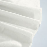 Close-up of white pleated face mask fabric with stitched edge