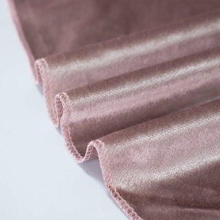 Pink velvet fabric close-up with soft ruffled edges
