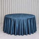Round table with blue satin tablecloth in elegant event setting